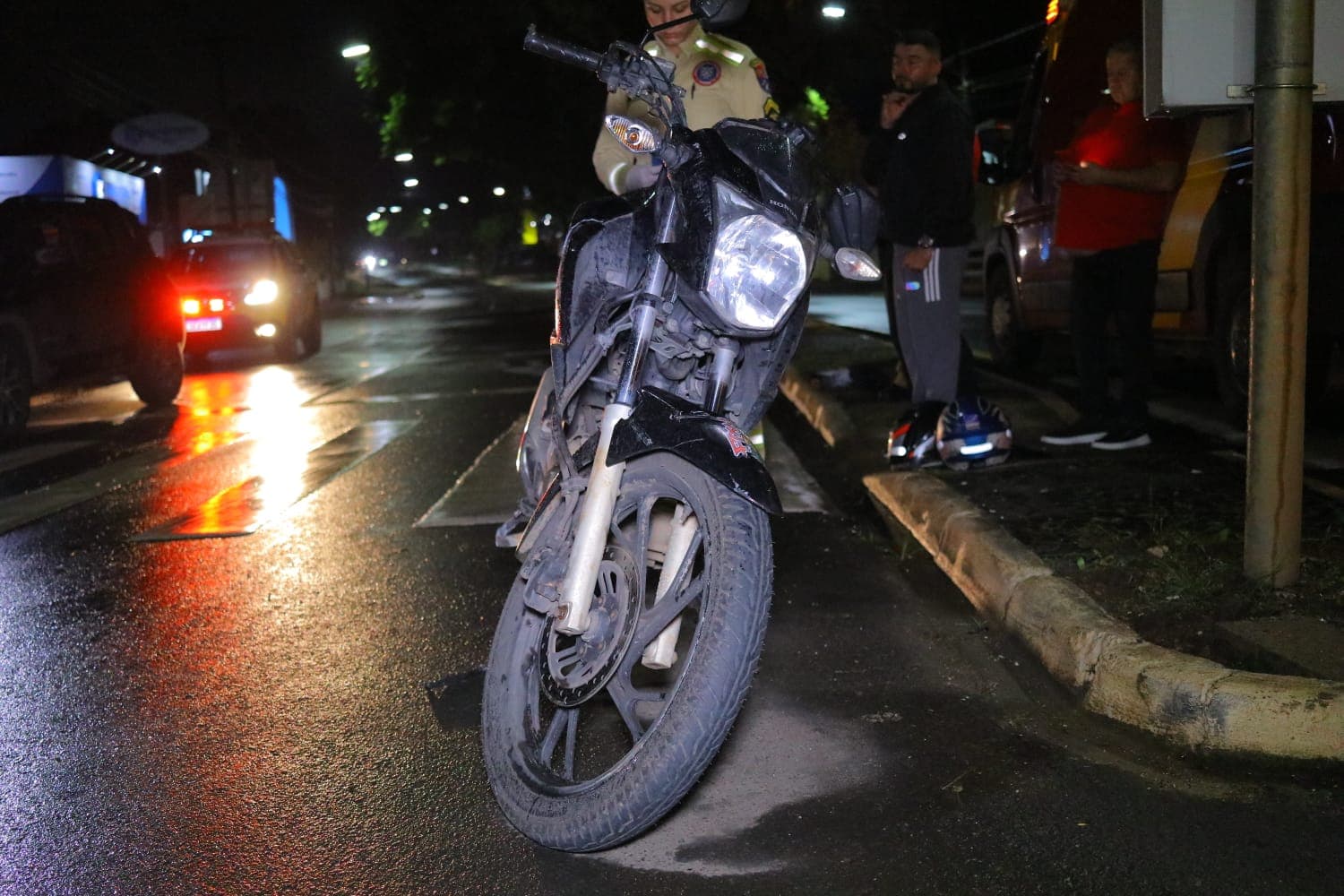 Motociclista tenta atravessar no meio de veículos no sinal, colide e acaba ferido em PG