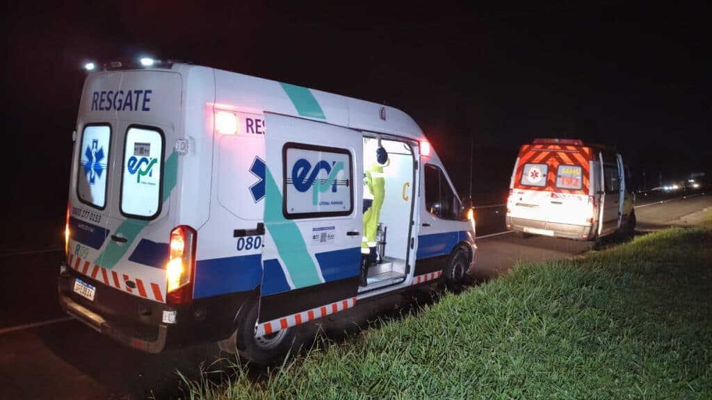 Uma ocorrência investigada como possível atropelamento na PR-151 mobilizou equipes de emergência na noite desta sexta-feira (28), no km 316 da rodovia, em Carambeí, próximo à divisa com Ponta Grossa. Uma mulher, com idade estimada entre 25 e 35 anos, foi encontrada caída no acostamento e chegou a sofrer uma parada cardiorrespiratória durante o atendimento. As primeiras informações recebidas no local apontavam para um atropelamento, com a possibilidade de que um veículo tivesse atingido a vítima e deixado a região. No entanto, até a última atualização, não havia confirmação oficial sobre a dinâmica da ocorrência nem testemunhas que pudessem afirmar que a mulher estava atravessando a rodovia no momento em que ficou ferida. A concessionária EPR Litoral Pioneiro teria sido acionada pelo telefone 0800 após populares encontrarem a mulher caída às margens da PR-151, na região próxima à Fazenda Frank’Anna. Médico que passava pelo local iniciou atendimento Segundo informações apuradas no local, um médico que passava pela rodovia percebeu a situação e prestou os primeiros atendimentos à vítima antes da chegada das equipes de emergência. Na sequência, equipes da concessionária e do Serviço de Atendimento Móvel de Urgência (SAMU) foram mobilizadas. A mulher estava inconsciente e apresentava quadro considerado extremamente delicado. Durante o atendimento dentro da ambulância, a vítima sofreu uma parada cardiorrespiratória. Os socorristas, com apoio dos médicos presentes, realizaram as manobras necessárias e conseguiram reverter a parada. Mesmo após a retomada dos sinais vitais, o estado de saúde da mulher continuava gravíssimo. Mulher ainda não havia sido identificada Até a última atualização da ocorrência, a vítima ainda não havia sido identificada. A estimativa inicial é de que ela tenha entre 25 e 35 anos. Próximo ao ponto onde a mulher foi encontrada havia também um saco de estopa com objetos que podem pertencer à vítima. As circunstâncias serão verificadas pelas autoridades responsáveis pelo atendimento e pela apuração do caso. A região onde aconteceu o possível atropelamento na PR-151 fica no km 316, no trecho entre Carambeí e Ponta Grossa. Ainda não havia confirmação sobre qual veículo poderia estar envolvido na ocorrência. A informação inicial de que o motorista teria deixado o local também deverá ser apurada. O caso permanece cercado de informações preliminares. Novas informações sobre a identificação da mulher, seu estado de saúde e a dinâmica da ocorrência poderão esclarecer o que aconteceu na rodovia.