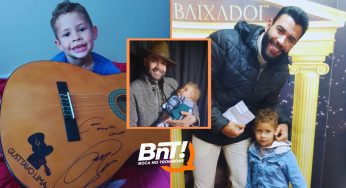 Gusttavo Lima presenteia criança de PG com um violão autografado